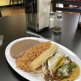 Two tacos, pork tamale, rice and beans Two tacos, pork tamale, rice and beans