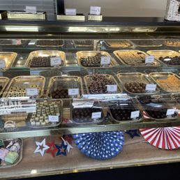 a variety of chocolates in a display case a variety of chocolates in a display case
