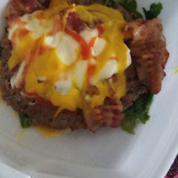 a cheeseburger in a styrofoam container a cheeseburger in a styrofoam container