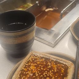 Sauce for dipping. Also in view, our two broths for the Hotpot.