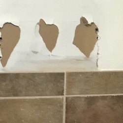 T J Maxx - Holes on the wall of the women's bathroom. I hope these holes do not share the men's bathroom wall.