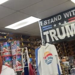 Lauritzen's Bp & Sport Shop - I stand with Trump flag and walls full of guns.