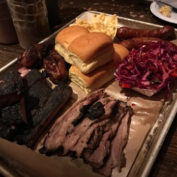 Fette Sau - Clockwise starting from bottom left: Ribs, Chicken wings, dinner rolls, mac & cheese, Italian sausage, spicy slaw, and the beef brisket! - Barbeque Near Me - Philadelphia, Pennsylvania