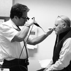 Palos Verdes Medical Group - Dr. Sher, a pediatric & adult allergist, is using a rhinoscope to examine Dr. Gorlick's nasal cavity.