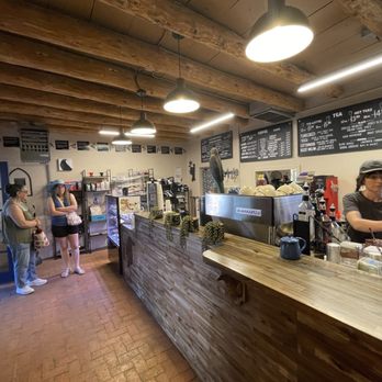 Blackbird Coffee House - A coffee shop interior with a wooden counter, menu boards, and customers waiting. A barista is preparing drinks behind the counter. - Coffee & Tea Near Me - Albuquerque, New Mexico