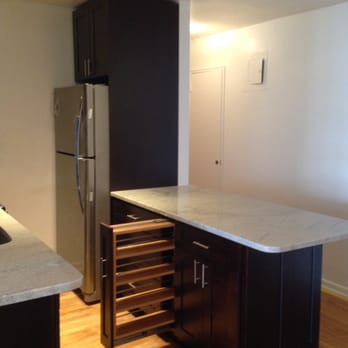 K-One Design Center - Y&E Condominium Remodel These dark Espresso cabinets surrounded by stainless steel hardware/appliances, white and grey veined stone counter - General Contractors Near Me - Brooklyn, New York