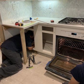 PRC Restoration & Construction - David and Eric working to find out how much damage is in the cabinets. - General Contractors Near Me - Rancho Cucamonga, California