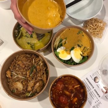 More Thai Kitchen - Pouring the golden curry over the khao soi - Thai Near Me - Mississauga, Ontario