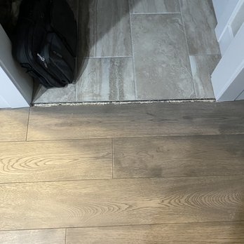 Interior Design Concepts - Transition between tile and hardwood floor between the garage and kitchen. - Interior Design Near Me - Windsor, Colorado