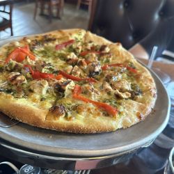 DiPalma's New York Pizza - White pizza with basil pesto, red peppers, artichoke hearts and grilled chicken!