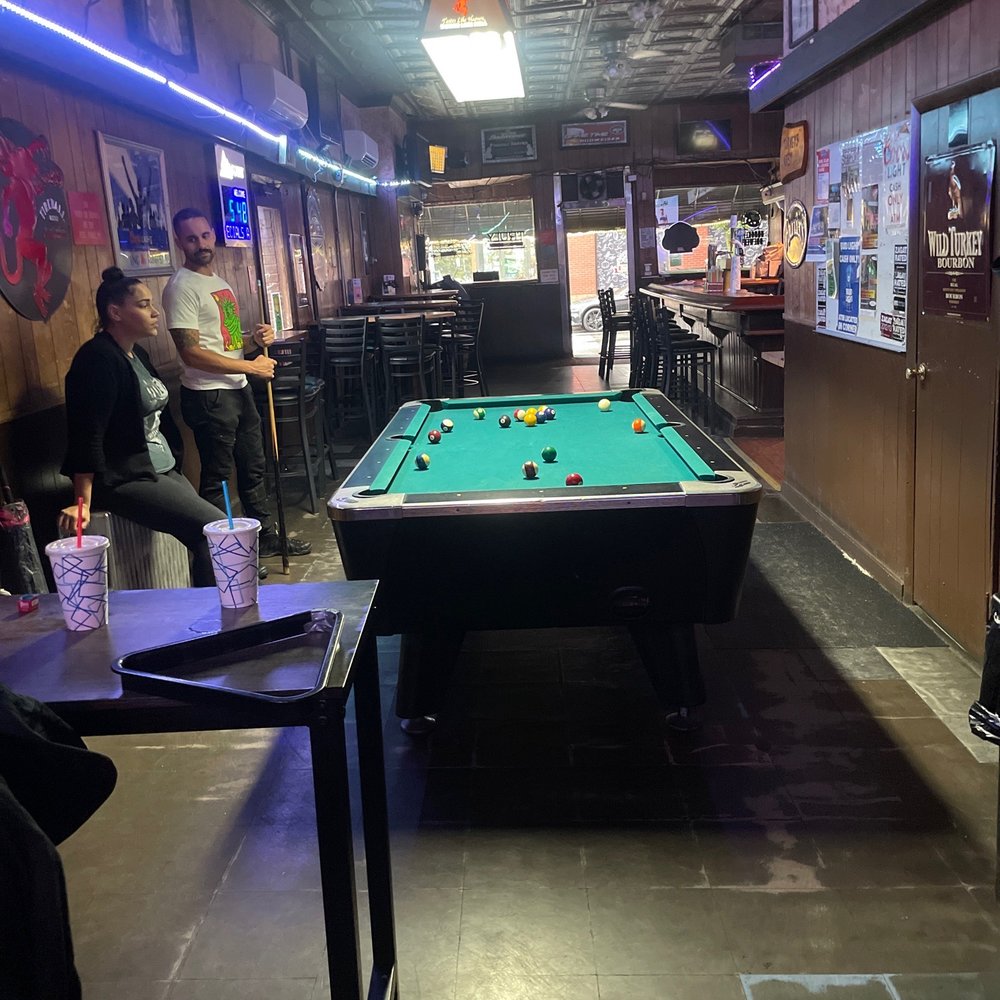 a pool table in the middle of the room a pool table in the middle of the room