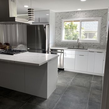 Fu Xin Construction - a kitchen with a stove and refrigerator - General Contractors Near Me