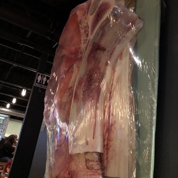 Chapel + Main - Art on wall. 4 foot piece of pork chop wrapped in cellophane. - New American Near Me - Dover, New Hampshire