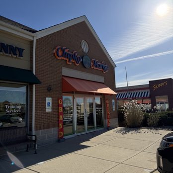 Chipko Market - View of storefront - Chipko Market storefront in St. Charles, IL, features a brick facade, signage, and an entrance with an orange awning, under a clear sky. - Specialty Food Near Me - St. Charles, Illinois
