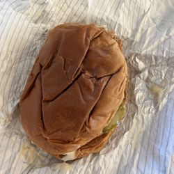KFC - Crispy chicken sandwich that look like somebody sat on it.