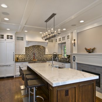 G&L and Sons Renovations - White perimeter cabinets with glass doors on top, wood tone island with sink. - General Contractors Near Me - Caldwell, New Jersey G&L and Sons Renovations - White perimeter cabinets with glass doors on top, wood tone island with sink. - General Contractors Near Me - Caldwell, New Jersey