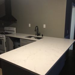 Kitchen & Bath Expo - Classical white quarts countertops with beautiful gray veins throughout and true white background,  zero radius corners single bowl sink