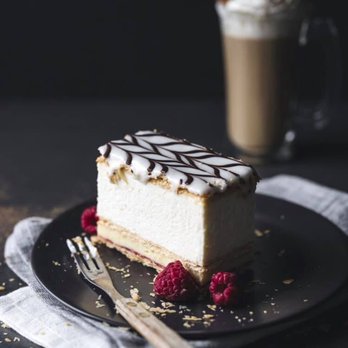 La Cage - Pâte feuilletée, de crème fouettée, de crème pâtissière, de confiture de framboises et recouverte d'un fondant vanille-chocolat. - Sports Bars Near Me - Boisbriand, Quebec La Cage - Pâte feuilletée, de crème fouettée, de crème pâtissière, de confiture de framboises et recouverte d'un fondant vanille-chocolat. - Sports Bars Near Me - Boisbriand, Quebec
