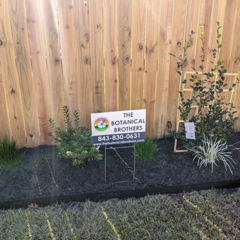The Botanical Brothers - a sign in front of a fence - Landscaping Near Me