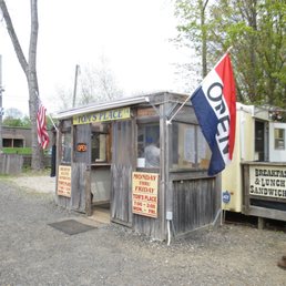 a man sitting on a bench in front of a booth
