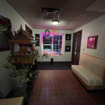 Green Basil - a long hallway with a bench and a clock - Thai Near Me - North Providence, Rhode Island