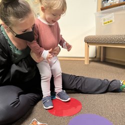 Littlefield Physical Therapy - Maisie learning how to jump with her therapist Delaney.