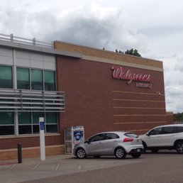 two cars parked in front of a walgreens store two cars parked in front of a walgreens store