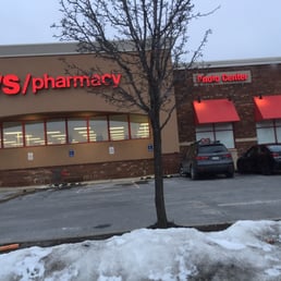 cars parked in front of a cvs pharmacy
