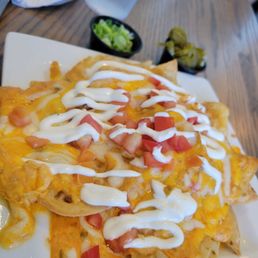 Seafood Nachos for two , green onions and jalapeños on the side. Seafood Nachos for two , green onions and jalapeños on the side.