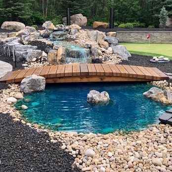 Muddy Boots Landscaping - a wooden bridge over a small pond - Landscaping Near Me - Mulhurst, Alberta Muddy Boots Landscaping - a wooden bridge over a small pond - Landscaping Near Me - Mulhurst, Alberta