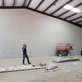 Jabco Services - a woman standing in a warehouse - Handyman Near Me