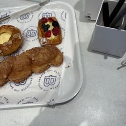 Left rear: custard pastry; front: toughest donut in town;right gut back: fruit pastry