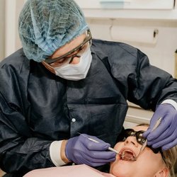 Mill Ridge Family Dental - Milton - Dentist providing dental treatment to a patient in Milton, GA