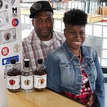 Dragon Moonshine - a man and a woman standing behind a counter - Distilleries Near Me - Charlotte, North Carolina