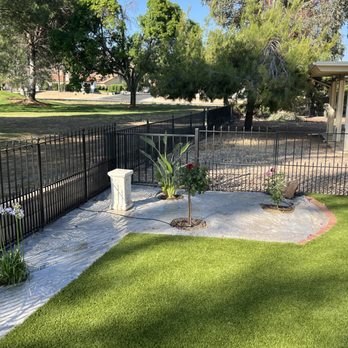 Providence Landscaping - a fenced backyard with a concrete bench - Landscaping Near Me Providence Landscaping - a fenced backyard with a concrete bench - Landscaping Near Me
