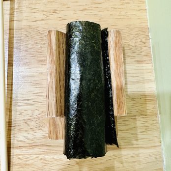 Midorie - a sushi roll on a chopping board - Sushi Bars Near Me - Miami, Florida