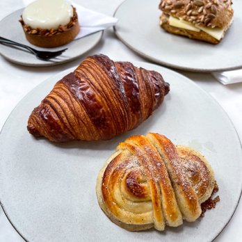 La Cabra - Back: rye tart & seeded sourdough cheese sandwich Front: croissant & cardamom bun - Bakeries Near Me - New York, New York