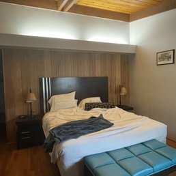 Queen room with lovely natural woods and modern bathroom with deluxe rain shower.