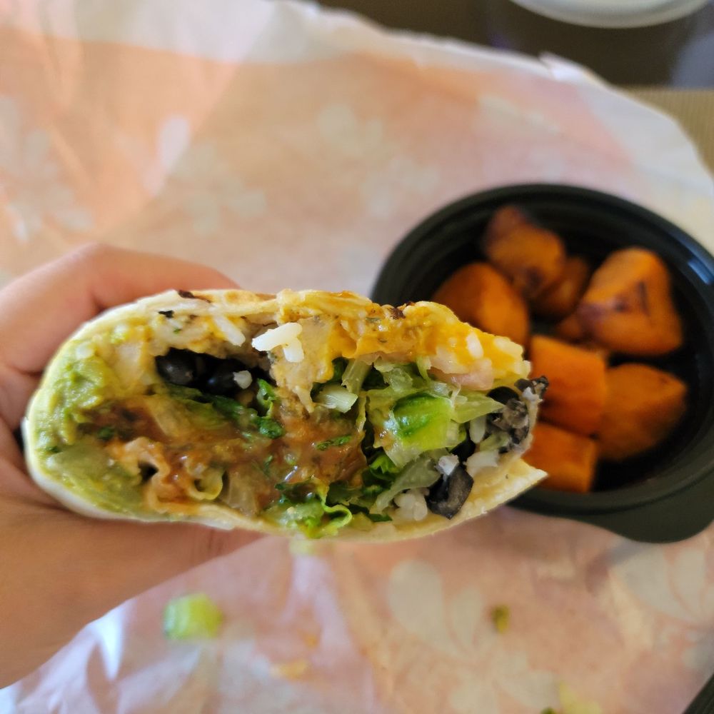 Baja chicken wrap with the sweet potatoes in the background. Baja chicken wrap with the sweet potatoes in the background.