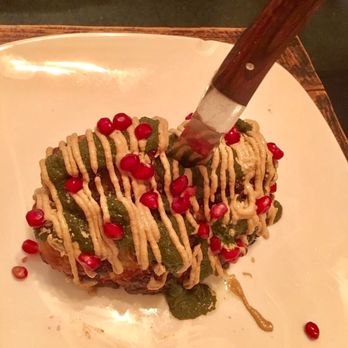 Sésamo - Tahini roasted cauliflower steak studded with pomegranate seeds. - Vegetarian Near Me - Barcelona, B Sésamo - Tahini roasted cauliflower steak studded with pomegranate seeds. - Vegetarian Near Me - Barcelona, B