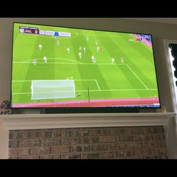 Tv mounted over fireplace