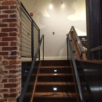 La Colombe - Stairs to the raised nook with a table for four. - Coffee & Tea Near Me - Washington, DC, District of Columbia