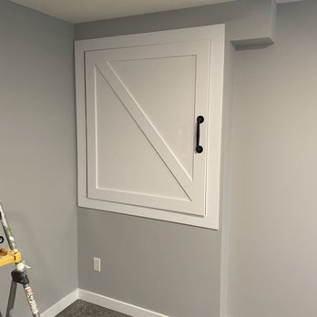 Modern Innovations - a white barn door in a room - General Contractors Near Me
