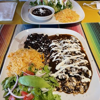 Casa Del Mariachi - Mole Chicken Enchiladas Plate (front) and Sopes plate (back) - Mexican Near Me - Seattle, Washington Casa Del Mariachi - Mole Chicken Enchiladas Plate (front) and Sopes plate (back) - Mexican Near Me - Seattle, Washington