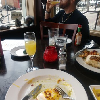 Ado's Kitchen & Bar - Half eaten, oh-so-good, Eggs Benedict on the left and Breakfast Burrito on the right. Obvi mimosas are good too! - Breakfast & Brunch Near Me - Boulder, Colorado