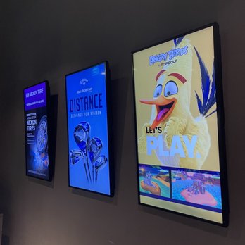 Topgolf - a row of movie posters on a wall - Golf Near Me - Charlotte, North Carolina Topgolf - a row of movie posters on a wall - Golf Near Me - Charlotte, North Carolina