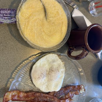 US Egg Brunch + Cocktails - Cheesy grits with 2 over easy eggs with bacon. - Breakfast & Brunch Near Me - Phoenix, Arizona US Egg Brunch + Cocktails - Cheesy grits with 2 over easy eggs with bacon. - Breakfast & Brunch Near Me - Phoenix, Arizona