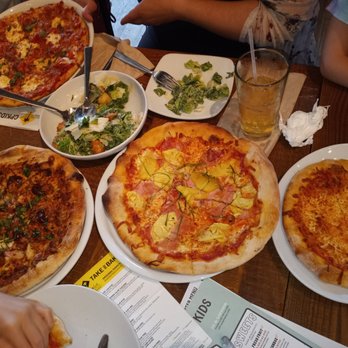 California Pizza Kitchen - Table full of Pizzas - Pizza Near Me - Glendale, New York