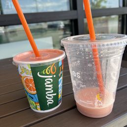 a plastic cup with a straw and a plastic cup with a straw