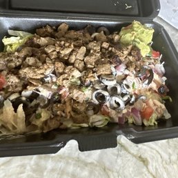 Burrito Bowl with Steak, Chicken, Black Beans, Black Olives, Guacamole, lettuce,  tomatoes, red onions, rice and the surcheros sauce